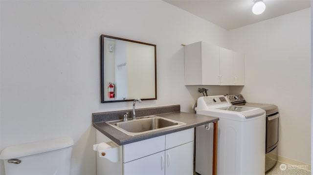 clothes washing area with separate washer and dryer and sink