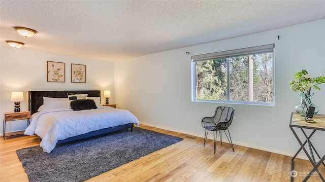 bedroom featuring hardwood / wood-style flooring and a textured ceiling