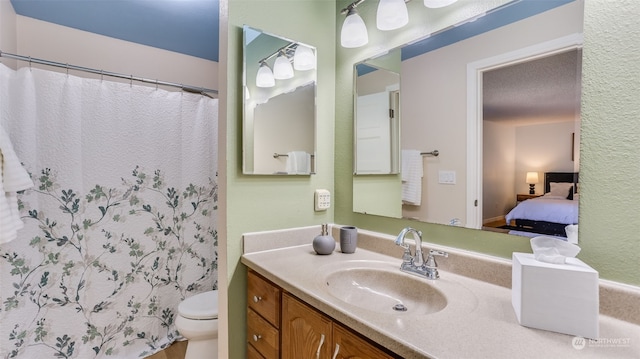 bathroom featuring vanity, toilet, and a shower with shower curtain