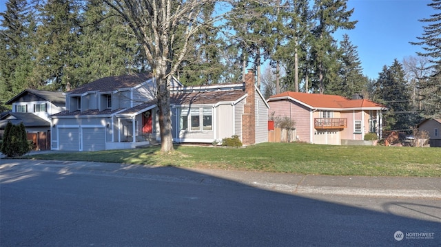 view of front of property featuring a garage and a front yard