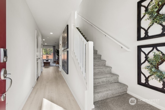 staircase featuring recessed lighting, baseboards, and wood finished floors