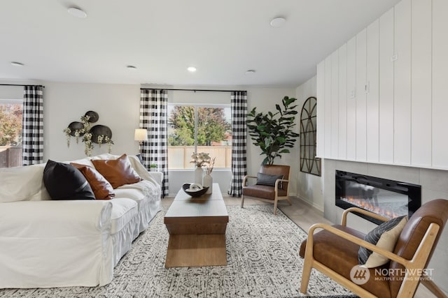 living room featuring a glass covered fireplace