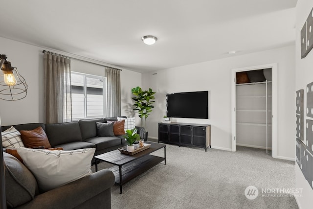 carpeted living area with baseboards