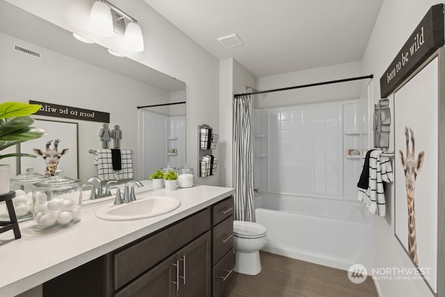 full bathroom with visible vents, toilet, vanity, and shower / tub combo with curtain