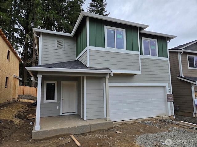 view of front facade featuring a garage, covered porch, board and batten siding, and a shingled roof