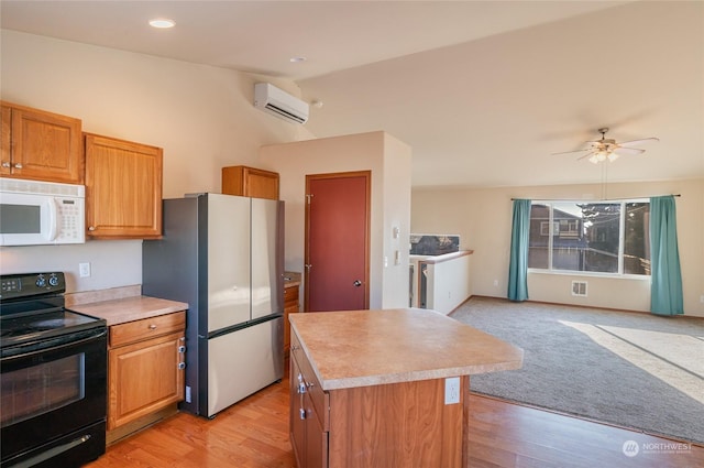 kitchen with a center island, vaulted ceiling, black electric range, an AC wall unit, and stainless steel refrigerator