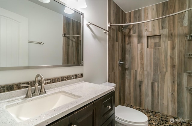 bathroom with a shower with curtain, vanity, and toilet