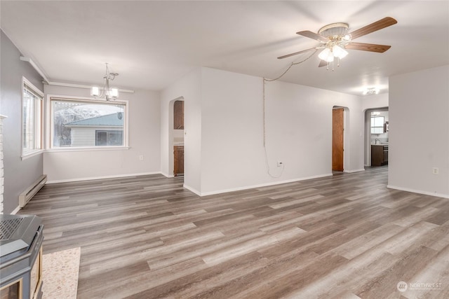 unfurnished living room with baseboard heating, ceiling fan with notable chandelier, and hardwood / wood-style flooring