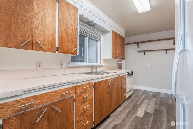 kitchen featuring dishwashing machine, sink, hardwood / wood-style floors, and white refrigerator