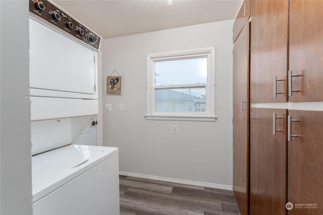 washroom featuring dark wood-type flooring and stacked washer / dryer