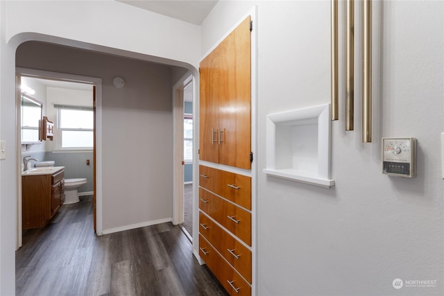 hallway with dark hardwood / wood-style flooring and sink