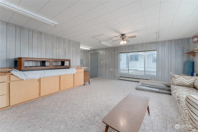 carpeted living room with ceiling fan and baseboard heating