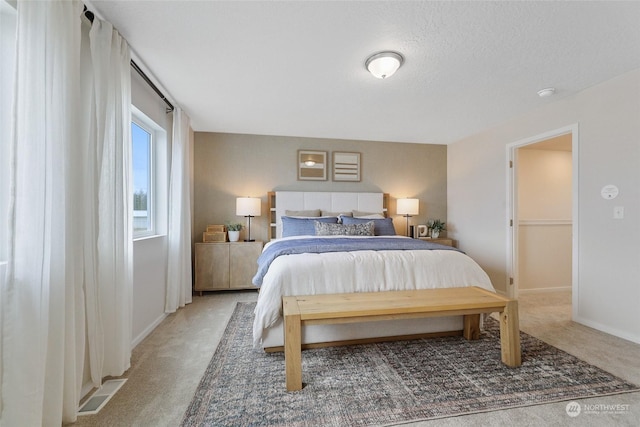 carpeted bedroom featuring a textured ceiling