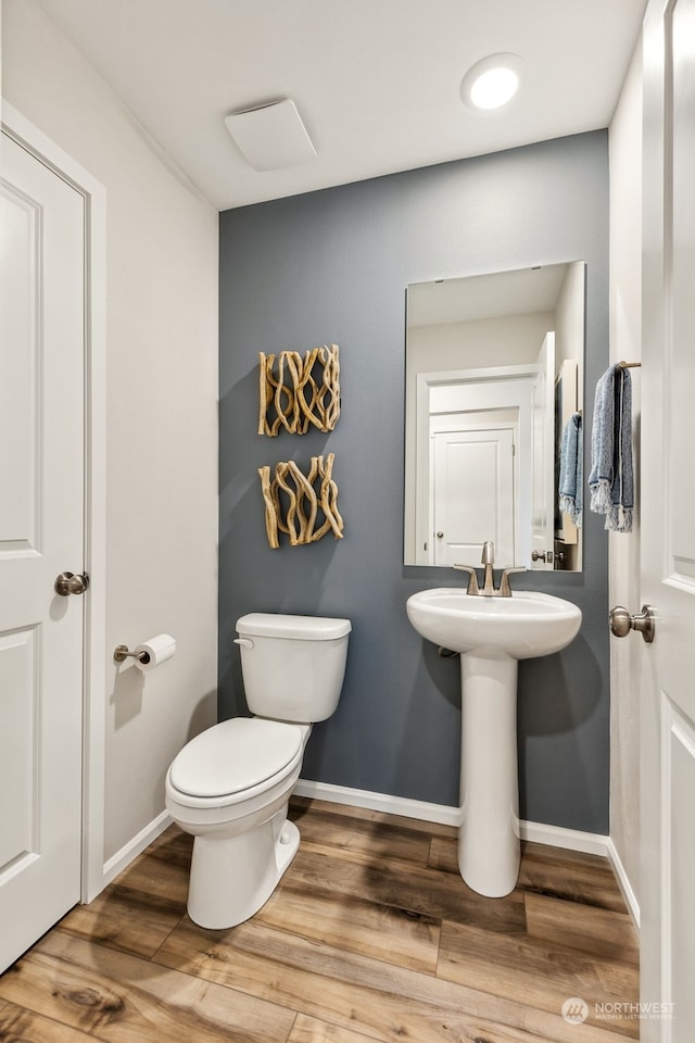 bathroom with sink, wood-type flooring, and toilet