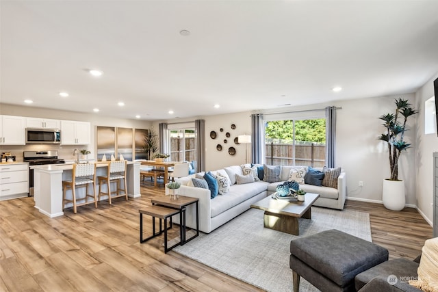 living room with sink and light hardwood / wood-style floors