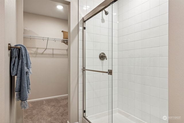 bathroom featuring a shower with door