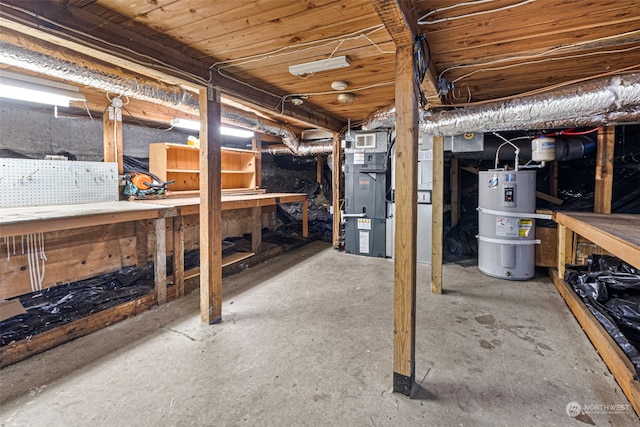 basement featuring water heater, heating unit, and a workshop area