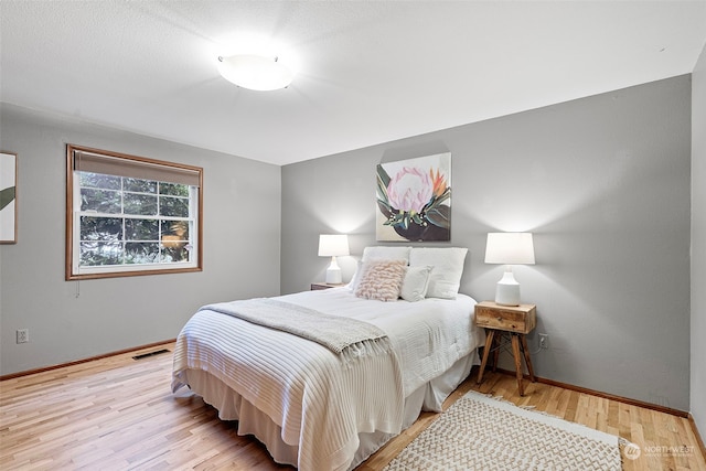 bedroom with light hardwood / wood-style floors