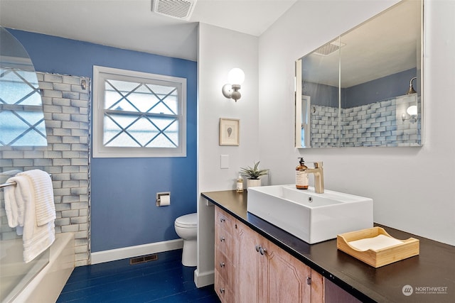 bathroom featuring vanity, wood-type flooring, and toilet