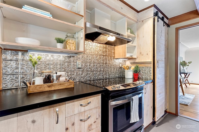 kitchen with wall chimney exhaust hood, tasteful backsplash, crown molding, electric stove, and a barn door