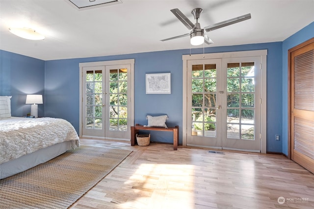 bedroom with access to exterior, french doors, and light wood-type flooring