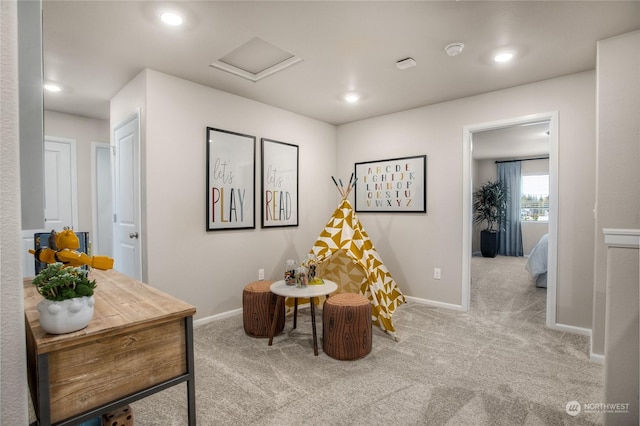 sitting room featuring light colored carpet