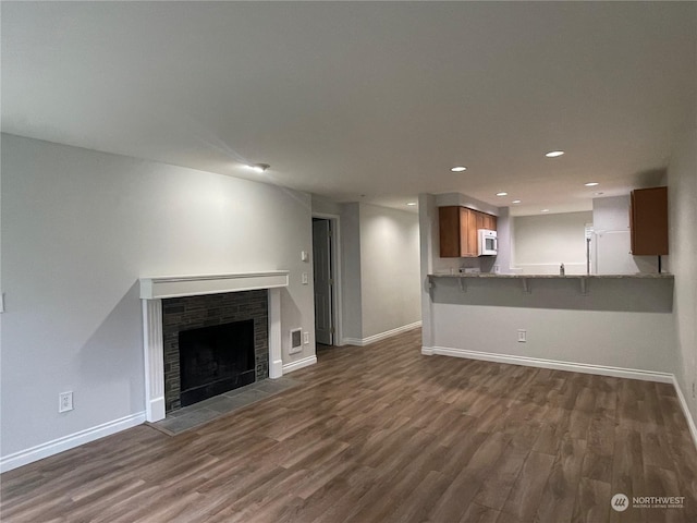 unfurnished living room with dark hardwood / wood-style floors