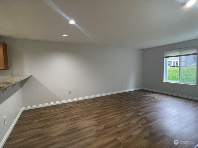 unfurnished living room featuring dark wood-type flooring