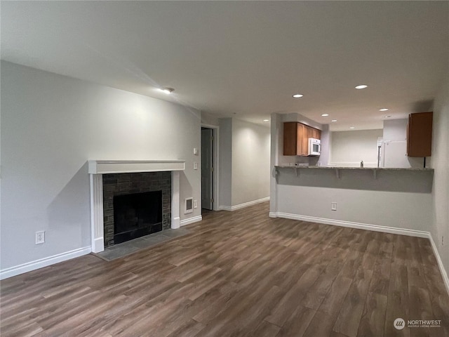 unfurnished living room with dark hardwood / wood-style floors