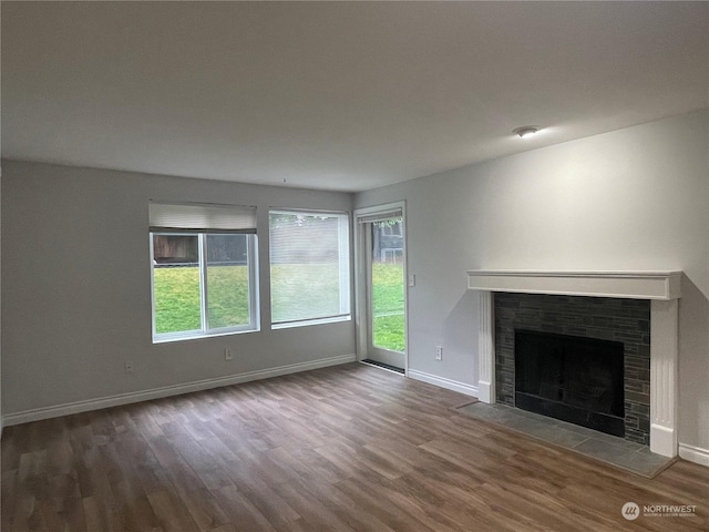 unfurnished living room with hardwood / wood-style flooring and a fireplace