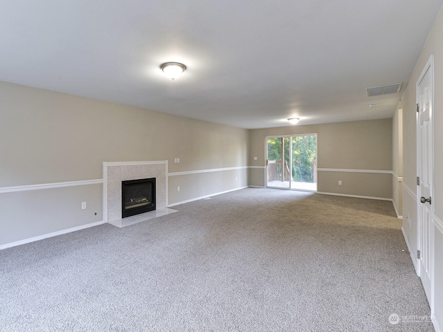 unfurnished living room with a premium fireplace and carpet flooring