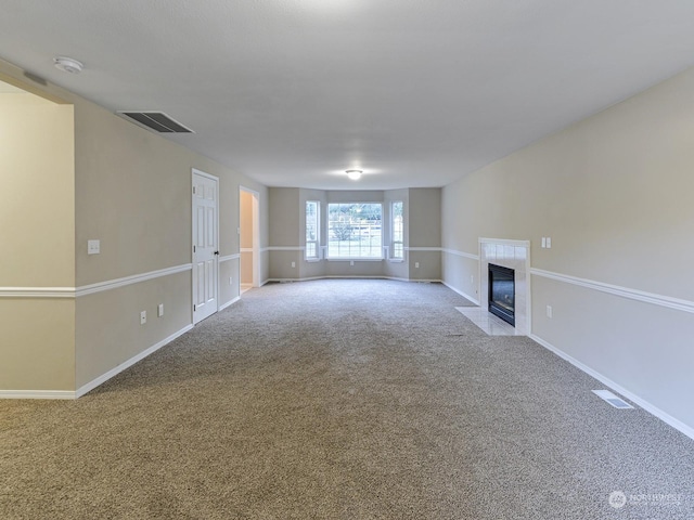 unfurnished living room with a fireplace and carpet flooring