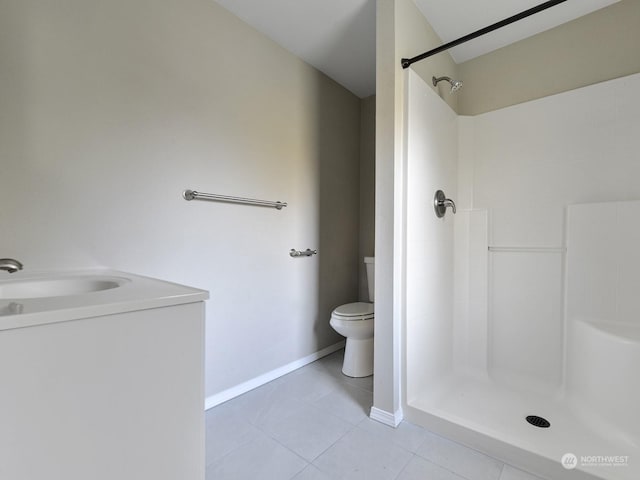 bathroom featuring walk in shower, tile patterned floors, and toilet