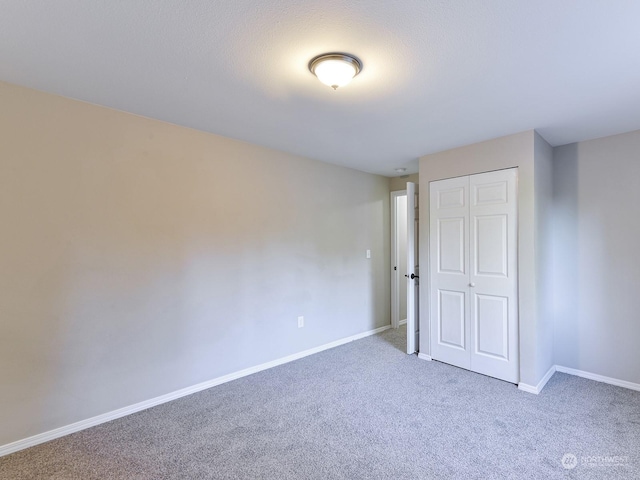 unfurnished bedroom with carpet and a closet