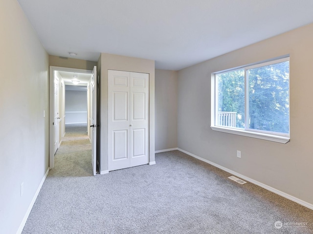 unfurnished bedroom with carpet floors and a closet