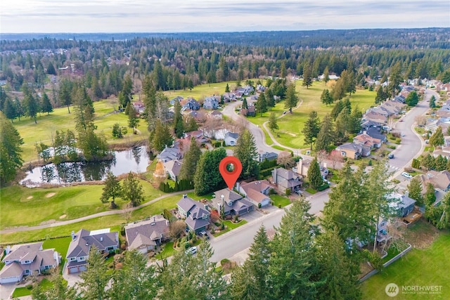 aerial view with a forest view, a residential view, and a water view