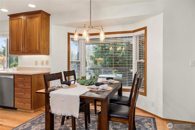 dining room with baseboards, recessed lighting, light wood-type flooring, and a chandelier