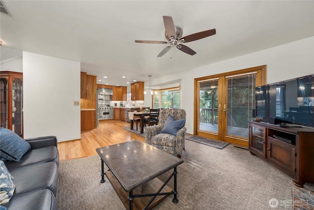 living room featuring recessed lighting, light wood-style floors, visible vents, and ceiling fan