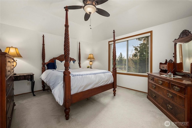 bedroom featuring light carpet, baseboards, ceiling fan, and vaulted ceiling