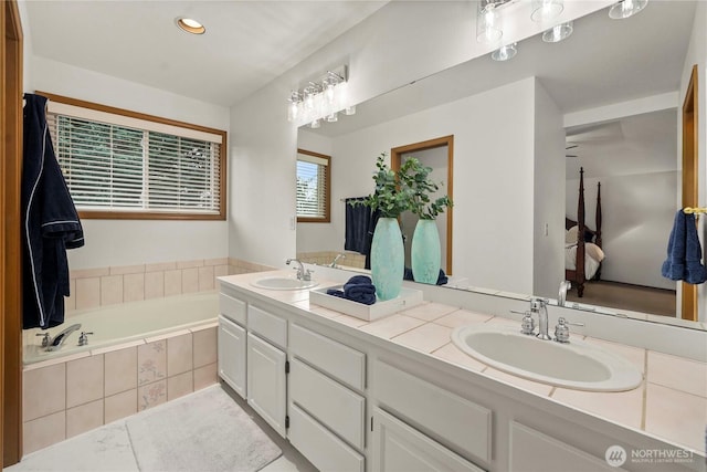 full bath featuring a sink, recessed lighting, a bath, and double vanity