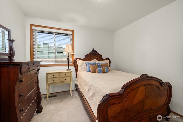 bedroom featuring visible vents and light colored carpet