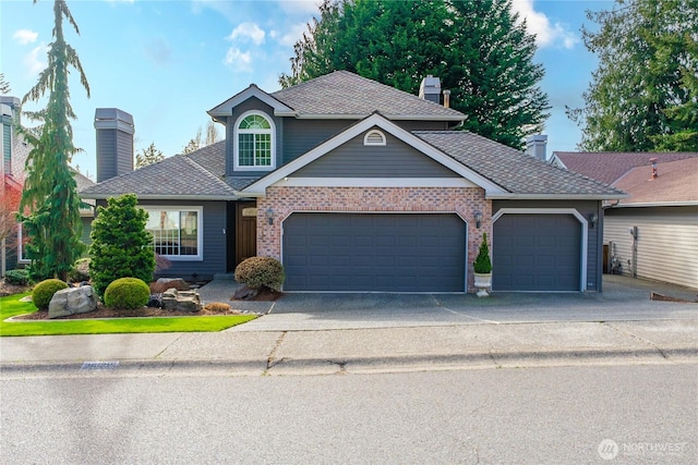 traditional-style house with driveway, an attached garage, a shingled roof, a chimney, and brick siding