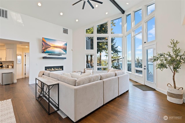 living room with dark hardwood / wood-style floors and a high ceiling