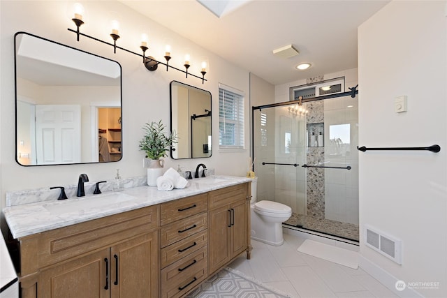 bathroom featuring an enclosed shower, vanity, and toilet