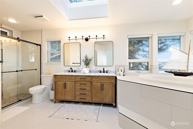 bathroom with tile patterned flooring, vanity, toilet, and a shower with shower door