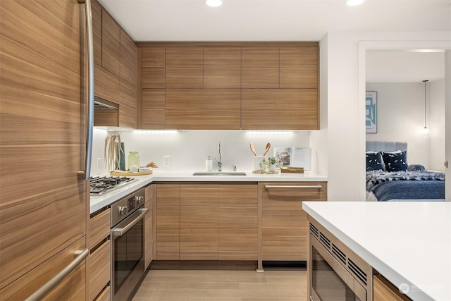 kitchen featuring hanging light fixtures, appliances with stainless steel finishes, and sink