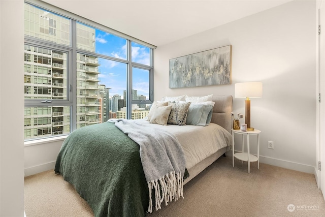 carpeted bedroom featuring expansive windows