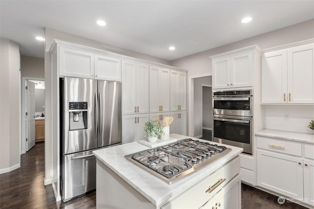 kitchen featuring white cabinetry, decorative backsplash, dark wood-type flooring, and stainless steel appliances