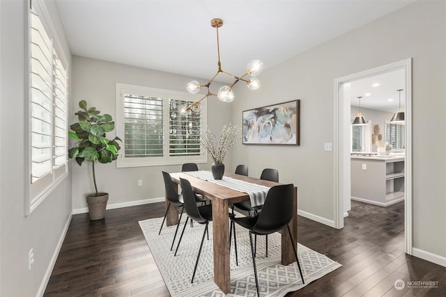 dining room featuring dark wood-type flooring, a chandelier, and plenty of natural light