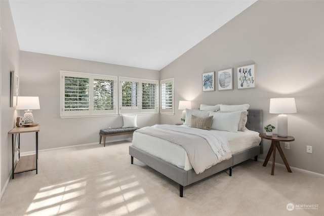 bedroom featuring light carpet and vaulted ceiling